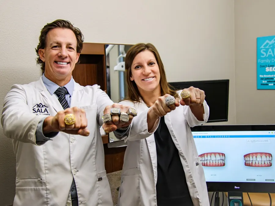 Dr. Jason Sala and Dr. Christina Knapp holding up their AACA Fellowship rings.
