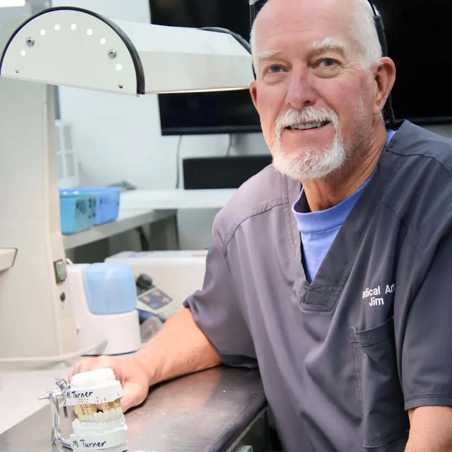 A dental technician at the bench in the practice's in-house lab.