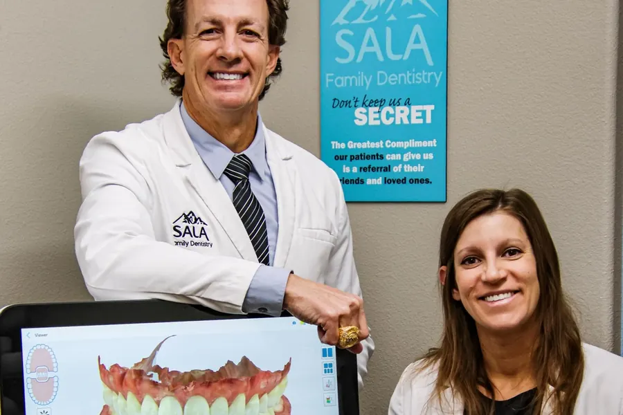 Dr. Jason Sala and Dr. Christina Knapp with a digital scan on screen.